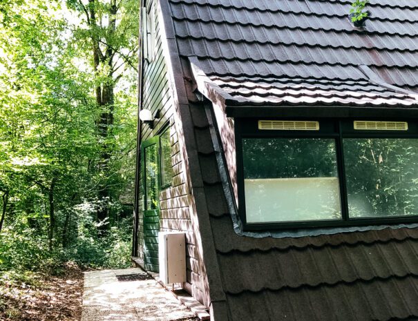 Boshuisje huren - vakantiehuisje durbuy voorkant met zon